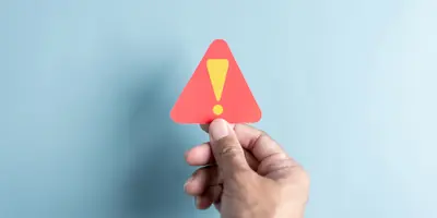 System warning caution sign symbol as a paper cut out. Notification error and maintenance concept.